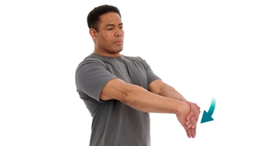 Person performing a wrist flexor stretch to relieve forearm and elbow tension.