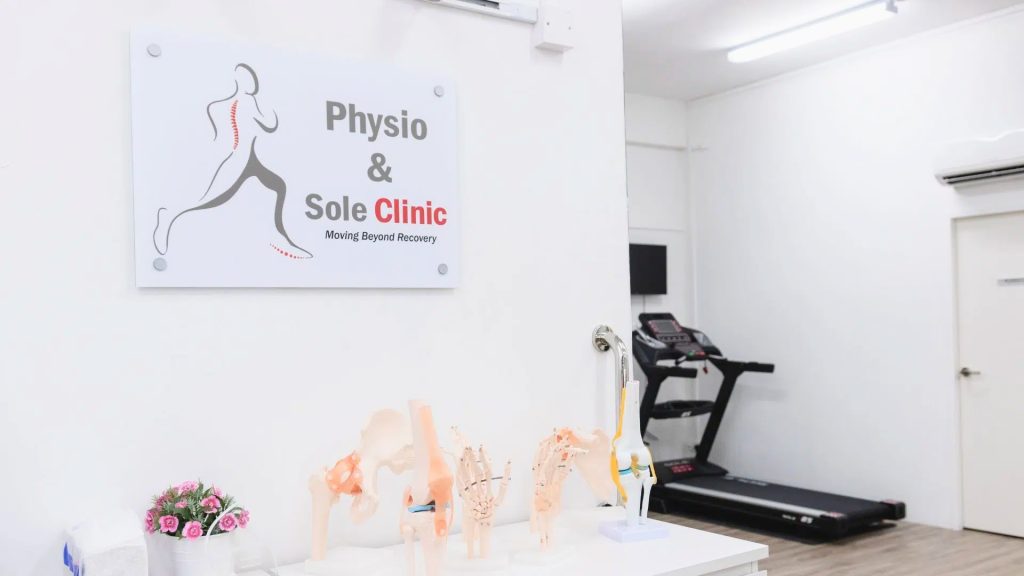 Physio & Sole Clinic interior showing clinic signage, anatomical models, and rehabilitation equipment.