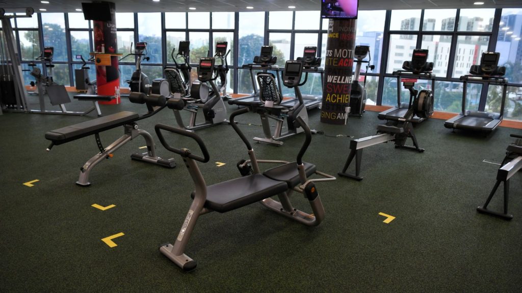 Indoor gym with shared exercise equipment and flooring, illustrating communal environments where moisture can increase fungal infection risk.
