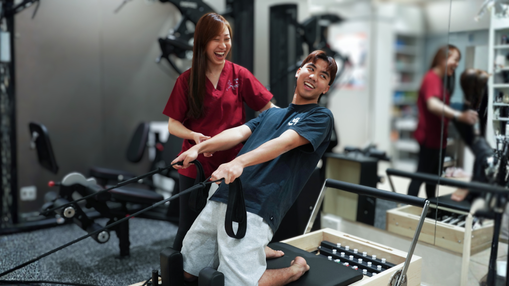 Physiotherapist coaching a patient through a resistance exercise during a rehabilitation session.