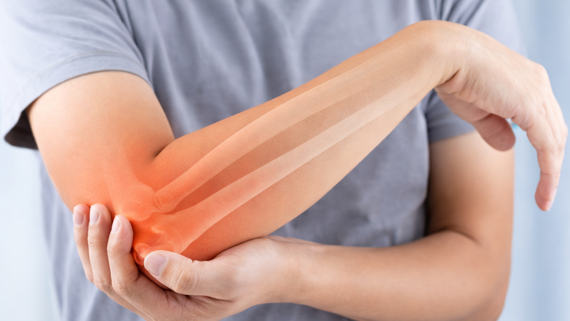 Active adult holding a painful elbow with highlighted joint area, illustrating elbow injury or dislocation symptoms