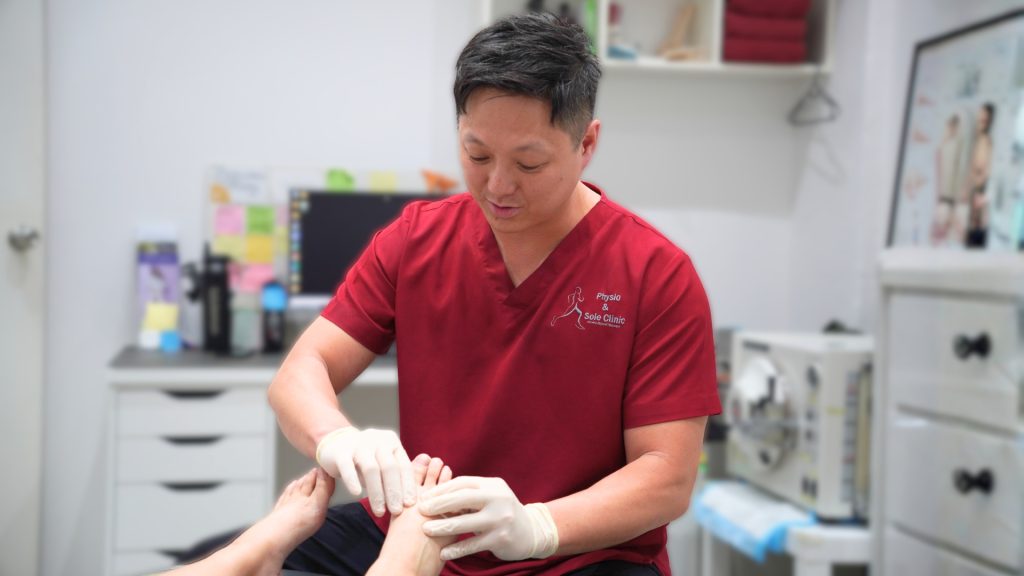 Podiatrist providing in-clinic ingrown toenail treatment during a consultation.
