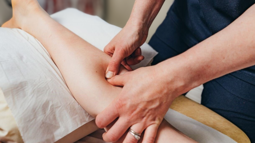 Therapist applying targeted pressure to forearm muscle during hands-on treatment