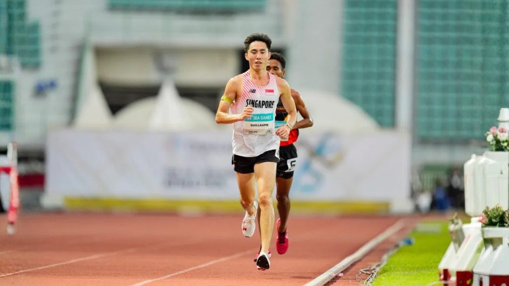 Track athlete sprinting during competition, representing return-to-sport goals after ACL rehab.