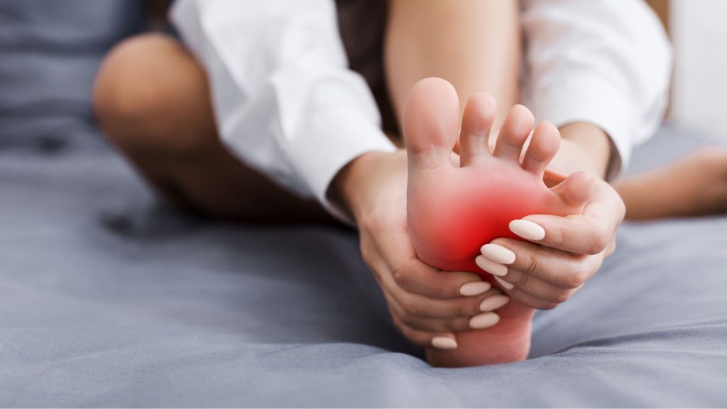 child holding foot in pain indicating possible foot problems children may need podiatry assessment