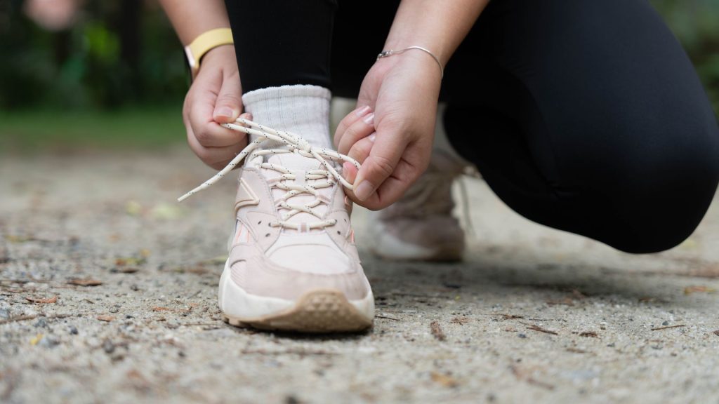 Person wearing covered shoes which can increase fungal nail infection risk in Singapore humid weather