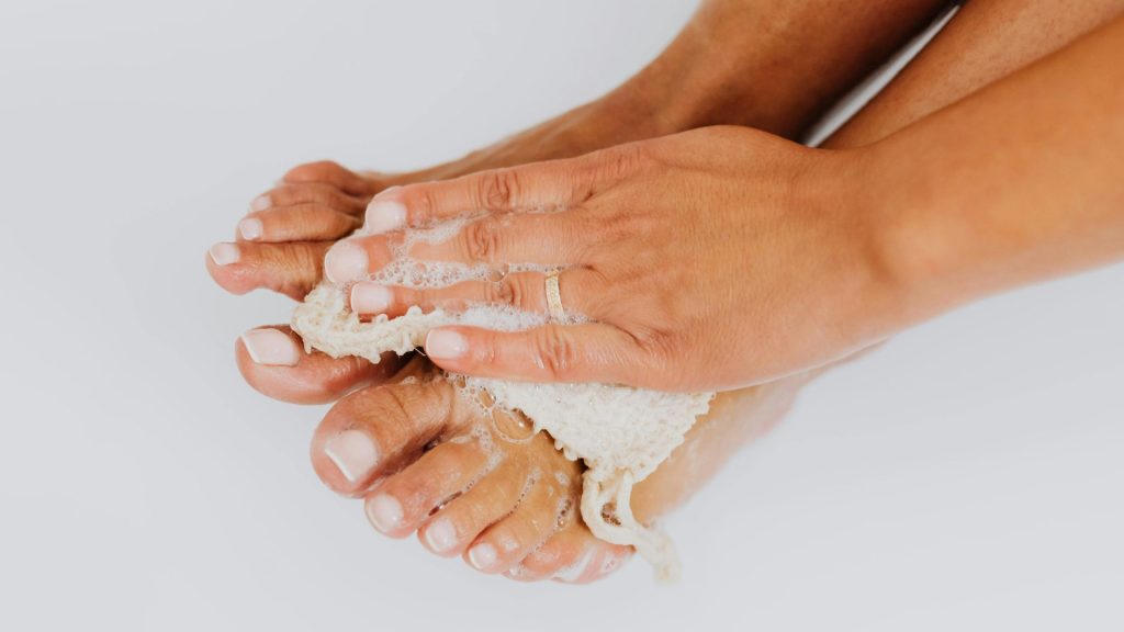 Washing feet to maintain hygiene and prevent fungal nail infection in humid climates