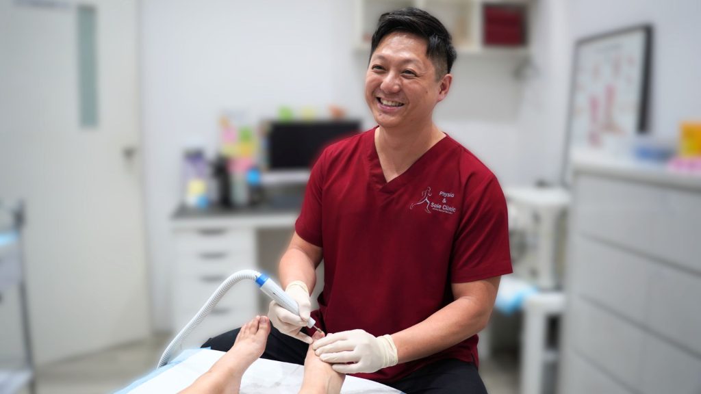 Podiatrist treating fungal nail infection at Physio & Sole Clinic in Singapore