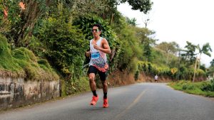 Runner training on a road for a long distance run, highlighting preparation strategies to prevent running foot pain