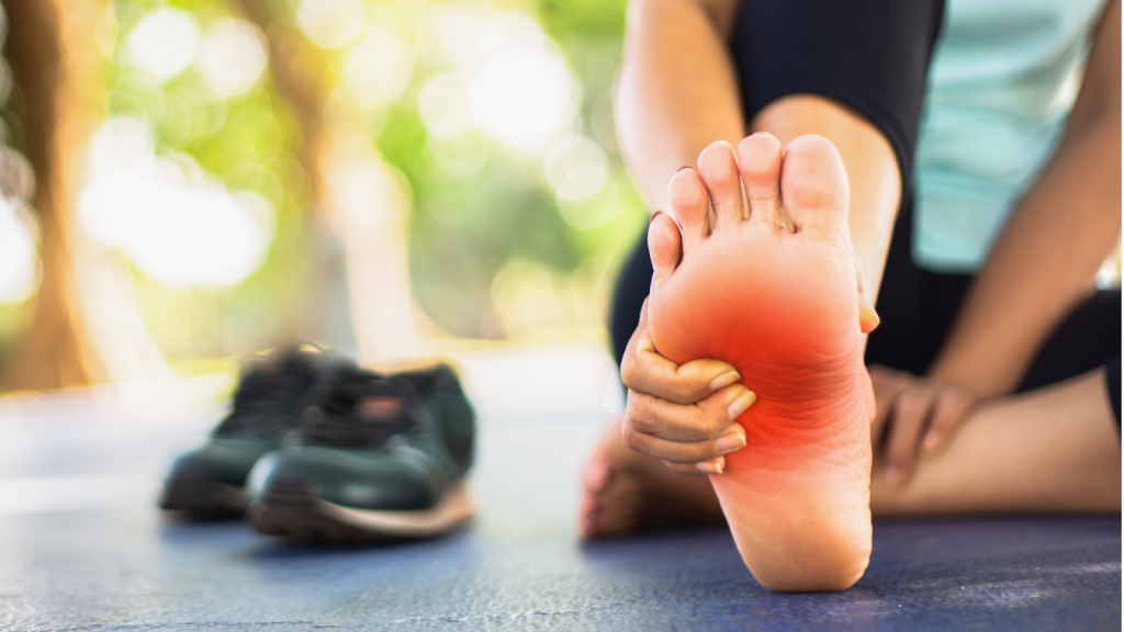 person experiencing heel pain while stretching foot after running illustrating need for podiatry care in Singapore