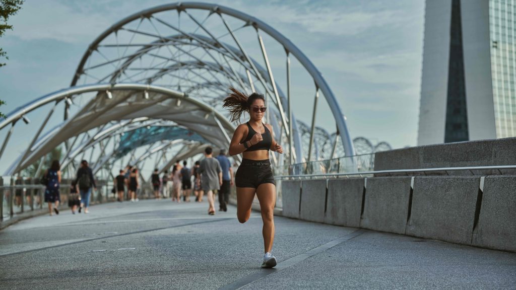 Woman jogging outdoors, representing activity that can lead to tendonitis injuries.
