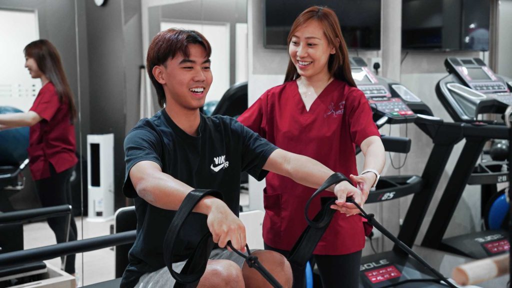 physiotherapist assisting patient with rehabilitation exercise during physiotherapy session singapore