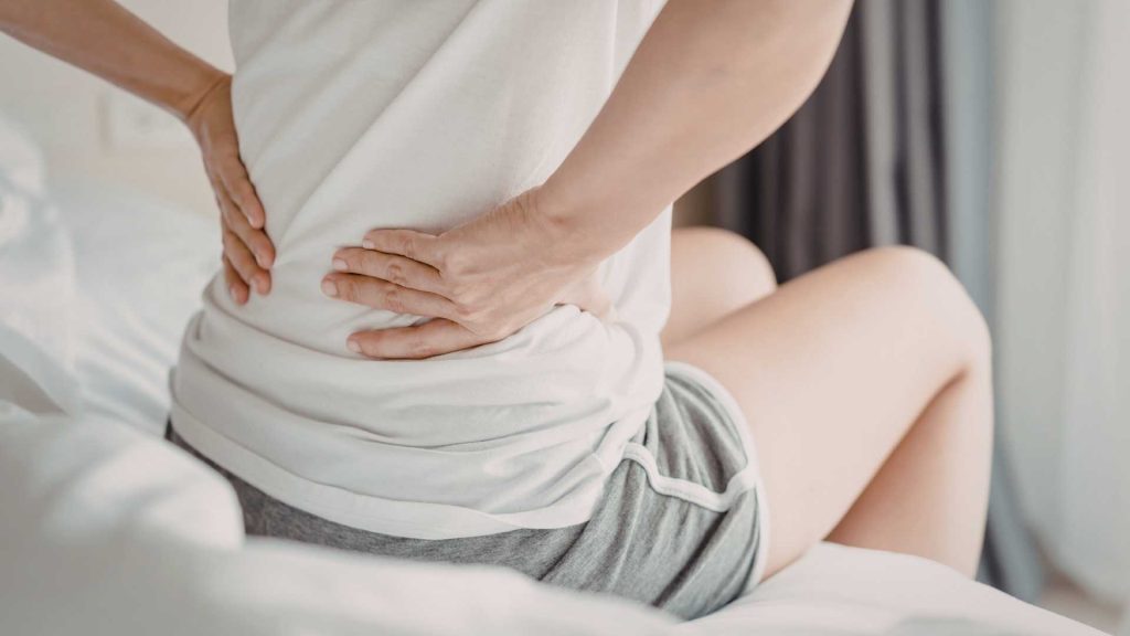 person experiencing lower back pain that may benefit from physiotherapy treatment singapore