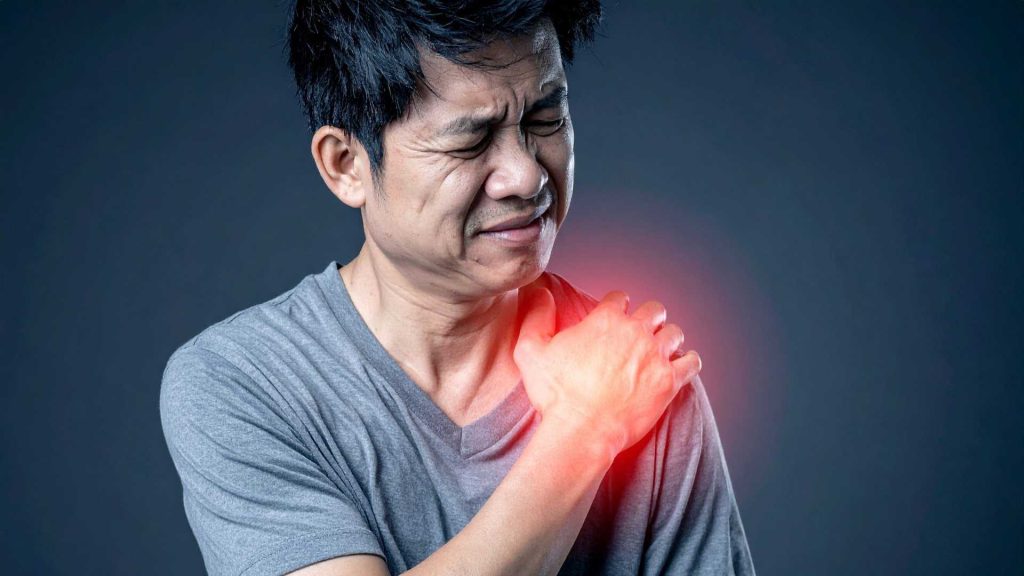 man experiencing persistent shoulder pain sign you may need physiotherapy singapore