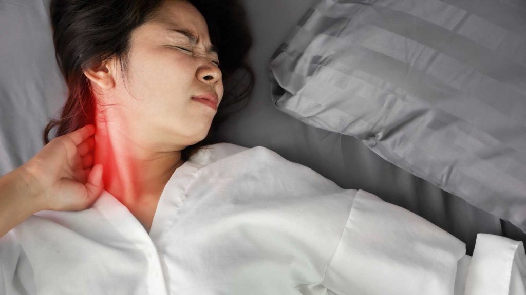 woman experiencing neck stiffness during daily activities sign you may need physiotherapy singapore