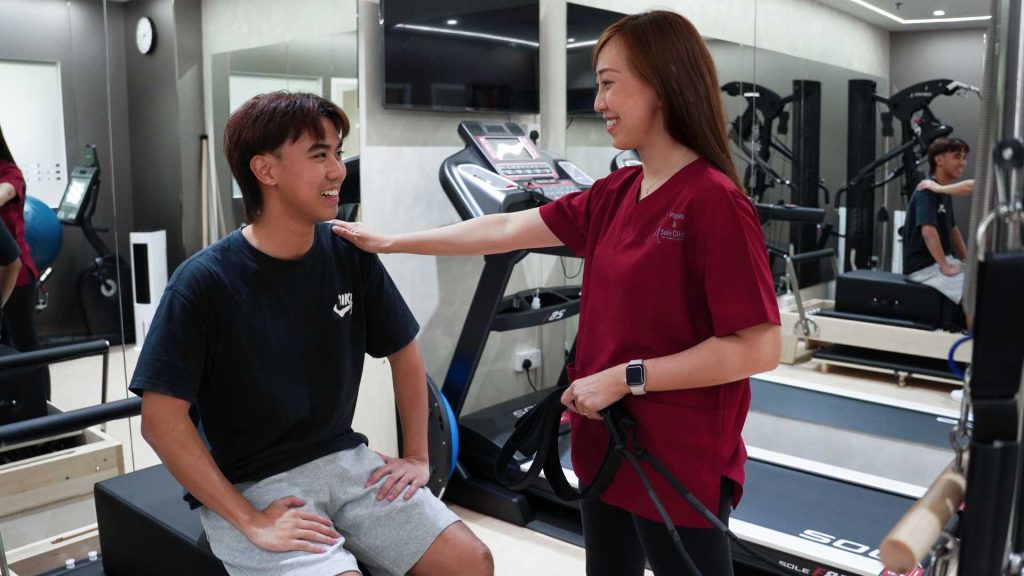 physiotherapist supporting patient during treatment session at physio and sole clinic singapore