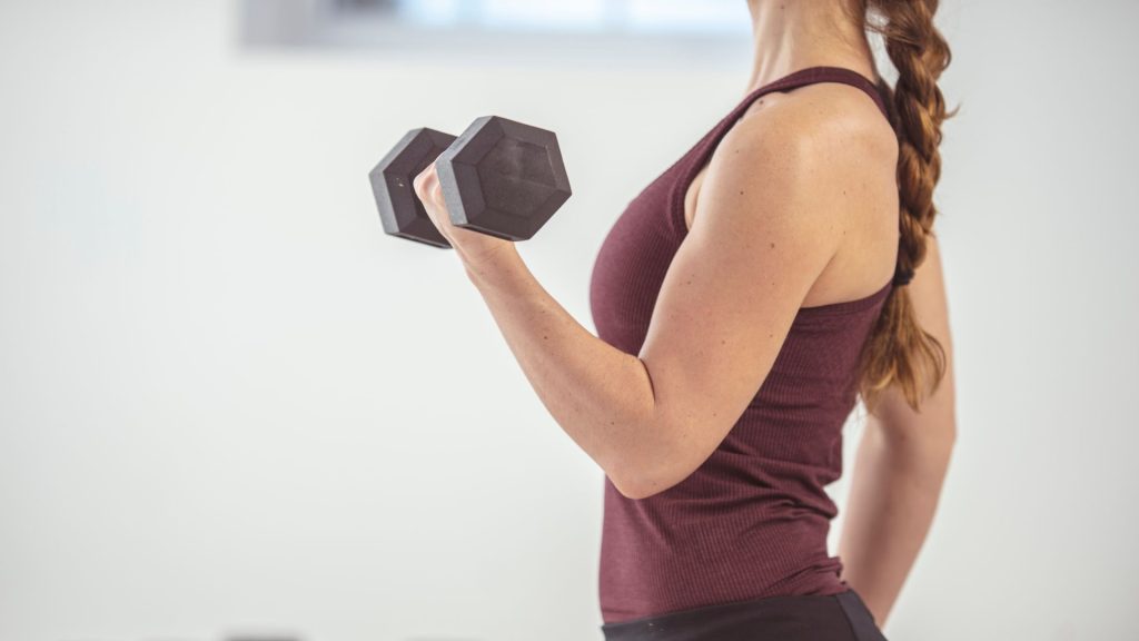 strengthening exercise using dumbbells to improve shoulder stability during physiotherapy rehabilitation Singapore