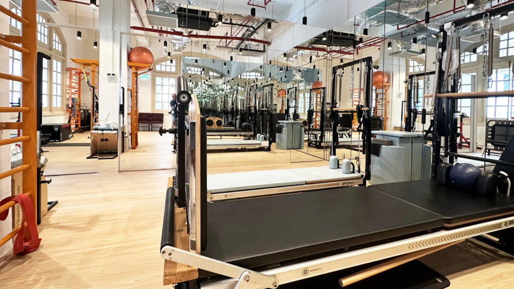 Modern physiotherapy clinic in Singapore with rehabilitation equipment, Pilates reformer, and treatment space
