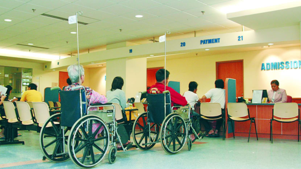 Patient waiting calmly in public hospital physiotherapy setting in Singapore for non-urgent treatment