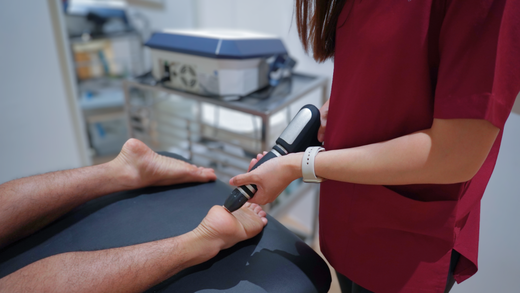 Shockwave therapy treatment for foot pain performed by physiotherapist

