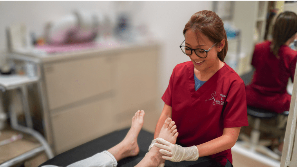 Podiatrist examining a patient’s toes and forefoot during a foot assessment. 