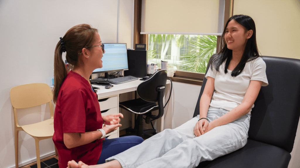 Podiatrist speaking with a patient during a foot health consultation in clinic. 